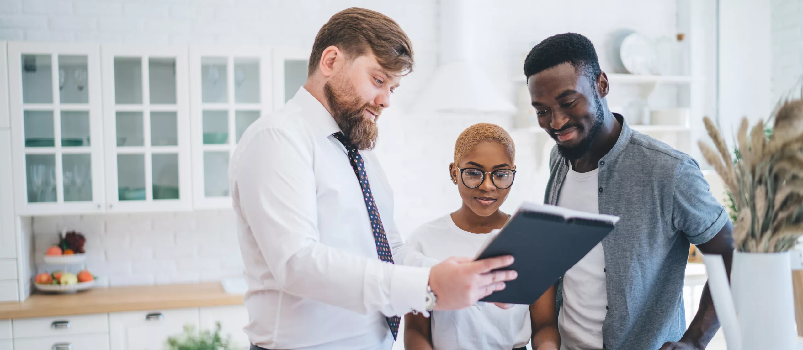 Couple Meeting with Atlanta real estate agent to buy or sell a home with AvenueWest Atlanta, property management and Corporate housing in Atlanta.